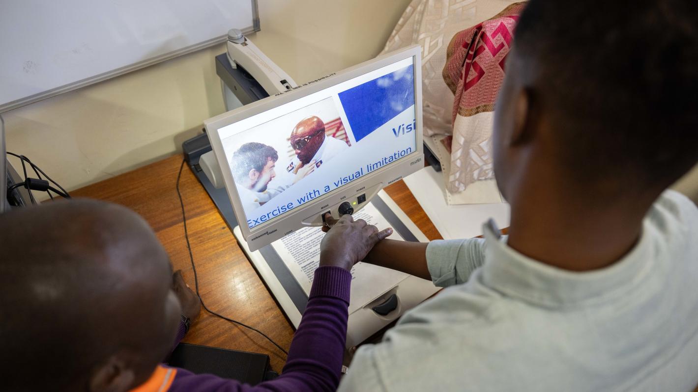 Photo of Abdirahman Mohamud Kulane, inspects one of the assistive tools during a week-long training on braille production and digital inclusion at KyU Hi-Techn Center in Kampala, Uganda.