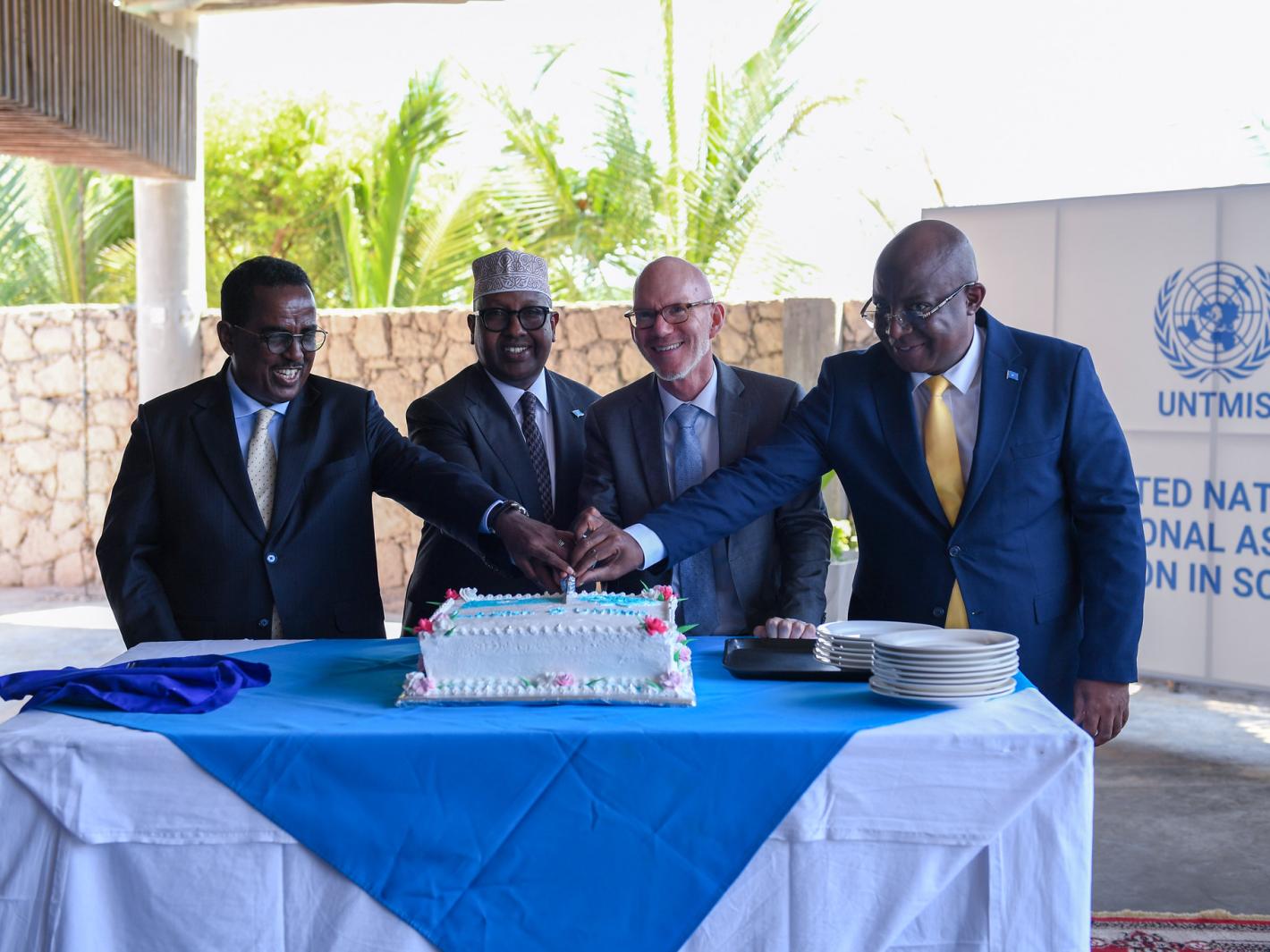 A photo of UN Special Representative James Swan with Somali ministers cutting a cake at the official launch of UNTMIS