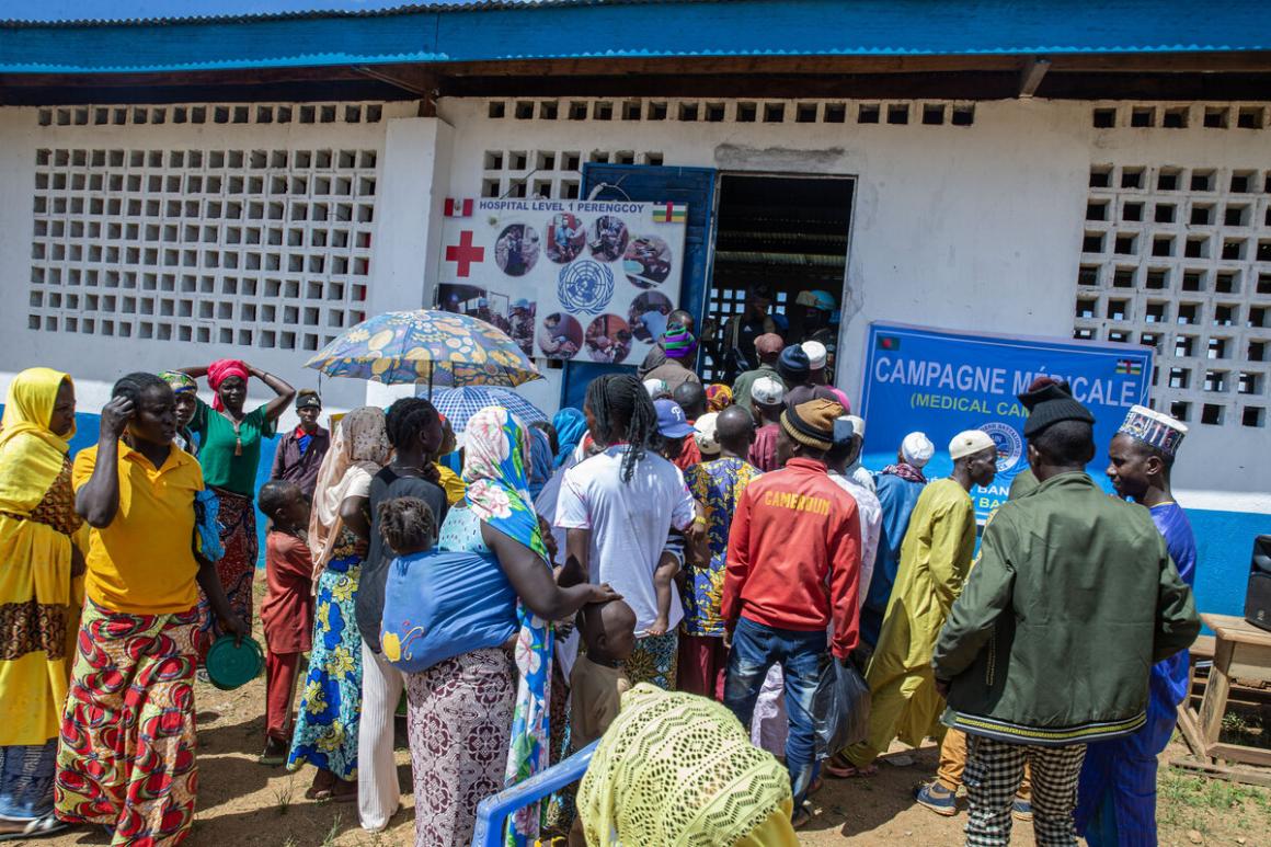 A crowd gathers outside of a medical centre.