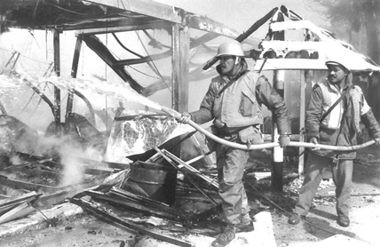 Extinguishing fires at the Fijian HQ at Qana after Israel shelling.